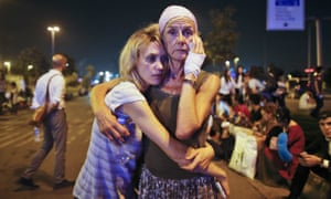 Passengers embrace each other as they wait outside Istanbul’s Ataturk airport.