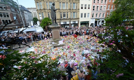 Floral tributes at a minute’s silence in St Ann’s Square, Manchester, to remember the victims of the terror attack at the Manchester Arena.