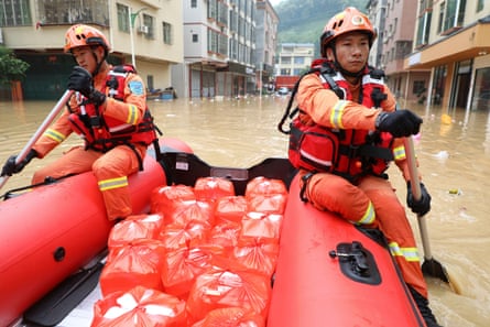 Rescuers deliver food by raft to people affected by the heavy rainfall in Lianjiangkou town, south China’s Guangdong province.