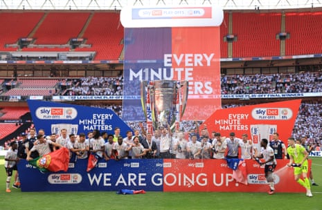 Bolton Wanderers celebrate with the trophy after clinching promotion