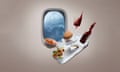 Photograph of a mock-up of inside a plane with a food tray and all it's food up in the air with a very stormy scene through the window