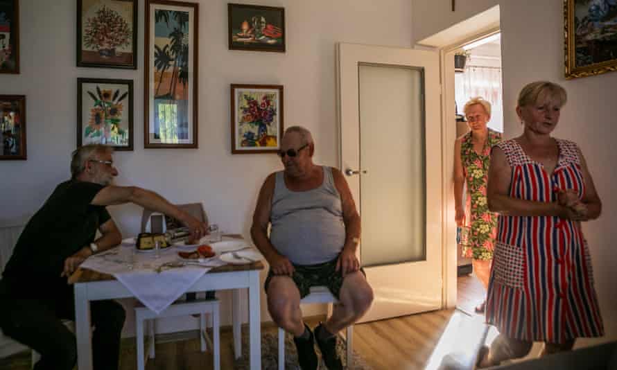 Stefan Bilas (left) visits his neighbours Jan Wolodzko and Henryka Wolodzko. Bilas’s wife, Halina, is on the right