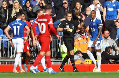 Young is shown a red card by referee Craig Pawson.