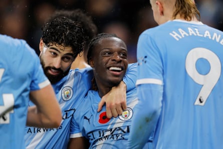 Jérémy Doku at the centre of Manchester City’s celebrations after scoring against Liverpool.