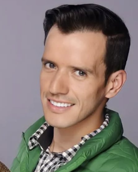 headshot of person wearing plaid button-down and green jacket