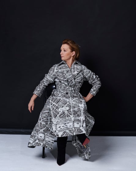 Lesley Manville portrait. She wears printed coat, by Dior. Boots, by Christian Louboutin.