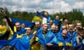 Ukrainian POWs shout slogans while they pose for a picture after a swap at an undisclosed location in Ukraine