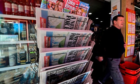 A man walks past a rack displaying British newspapers outside a supermarket in Benidorm in January