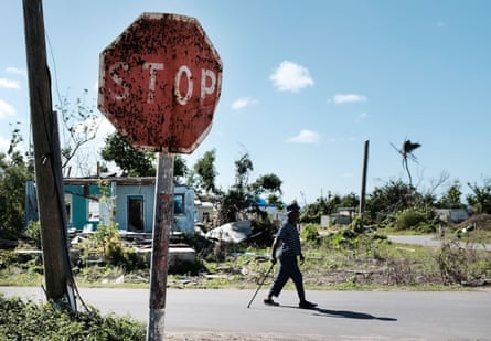 A man walks through a damaged neighborhood in the Caribbean island of Barbuda, which was nearly leveled by Hurricane Irma.
