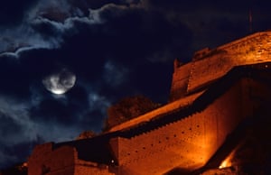 The supermoon rises behind Palamidi castle in Nafplio, Greece