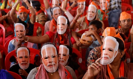 Supporters of India's prime minister Narendra Modi wear masks of his face, as they attend an election campaign rally in Meerut, India, 31 March, 2024. 