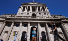 People walk in front of the Bank of England building