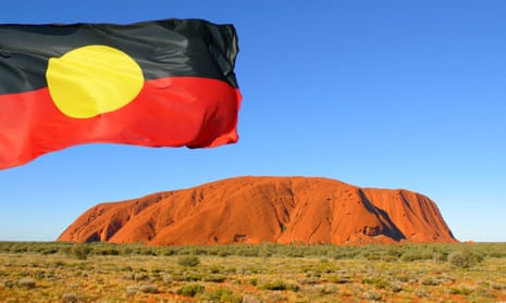 Aboriginal flag over Uluru