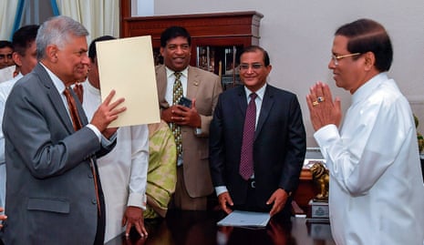 Sri Lankan president Maithreepala Sirisena gives a traditional greeting to re-appointed Prime Minister Ranil Wickramasinghe at the President Secretariat in Colombo, Sri Lanka.