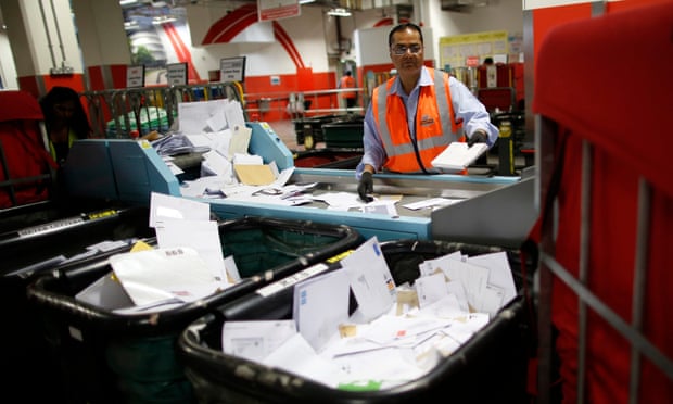 A postal worker at Mount Pleasant sorting office in London.