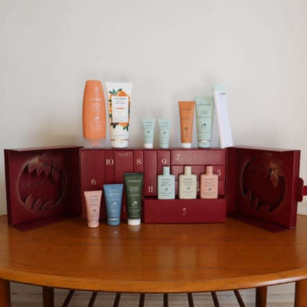 Liz Earle beauty Advent calendar open on a table, with its beauty products arranged alongside it