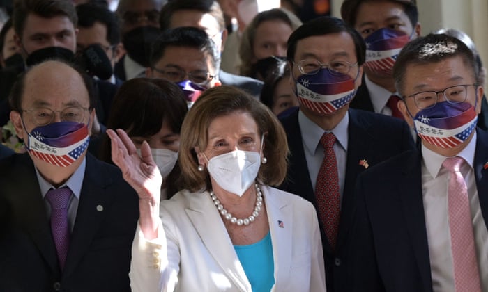 US House speaker Nancy Pelosi (C) waves to journalists during her arrival at the parliament in Taipei on Wednesday.