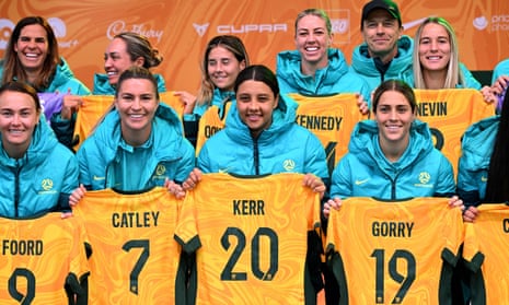 Australia's women's football captain Sam Kerr (2nd R), flanked by teammates Stephanie Catley (L), Caitlin Foord (2nd L) and Katrina Gorry-Lee Gorry (R), pose with the rest of their team after being presented with their jerseys at a public event in Melbourne on July 11, 2023 