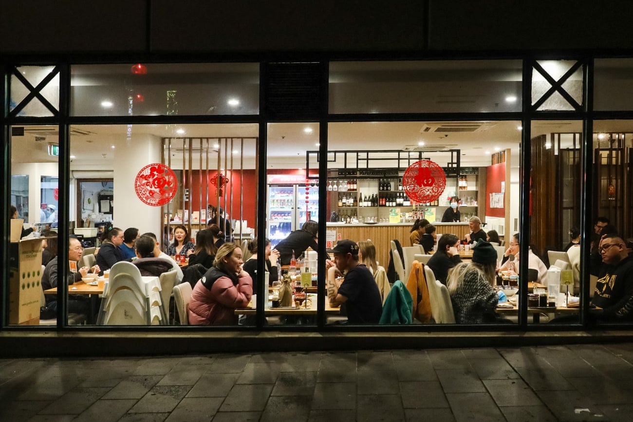 Diners sit at tables inside a restaurant in Melbourne's China Town.