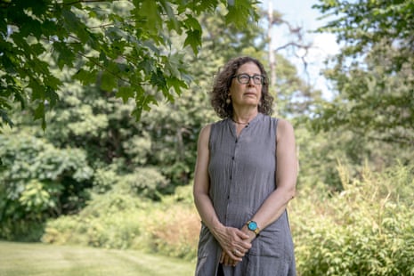 a woman stands in a yard