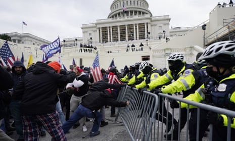 Capitol police struggle to prevent Trump supporters try from breaking through a barrier at the US Capitol on 6 January.