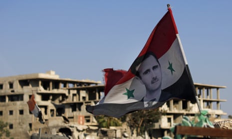 Now the clear winner: A Syrian flag bearing Bashar al-Assad’s image in Douma, near Damascus.