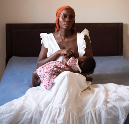 A self-portrait of a black mother breastfeeding her child, Monioluwa and Dola, during the lockdown in Hertfordshire, United Kingdom.
