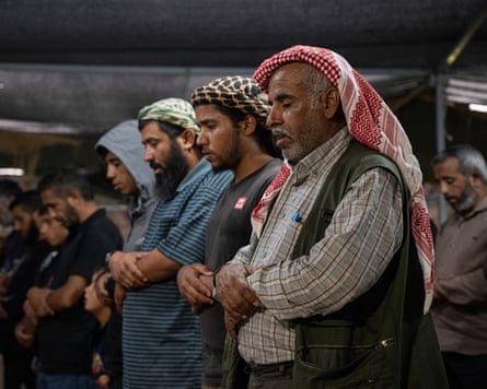 Relatives and friends of Palestinian activist Awdah Hathaleen gather in Umm al-Kheir in August to mourn his death the previous month.