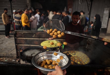 A man fries falafel at a makeshift takeaway spot in Gaza