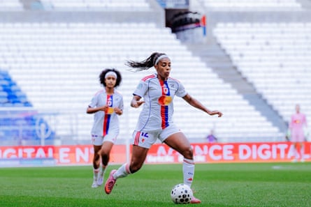 Lily Yohannes looks on as Ashley Lawrence surges forward with the ball against Marseille at Groupama Stadium in September.