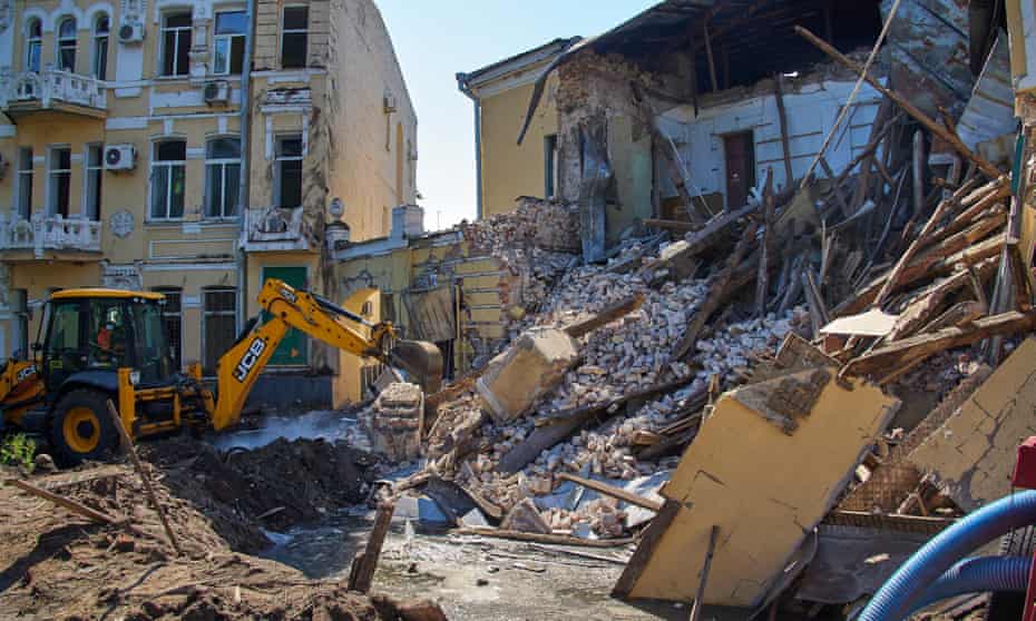 Ukrainian rescue teams clean debris following a Russian rocket strike in the city of Kharkiv, Ukraine, 6 July.