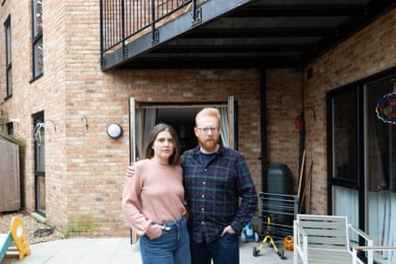 Rich Bell and his wife, Anna, stood in the courtyard outside their flat