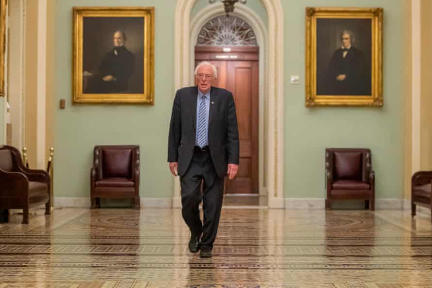 Bernie Sanders walks near the Senate chamber during the coronavirus relief bill at Capitol Hill in Washington DC, on 25 March.