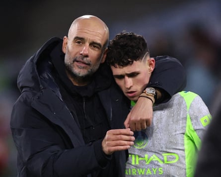 The then-Manchester City manager Pep Guardiola puts his arm around his player Phil Foden after their Premier League game away to Crystal Palace.
