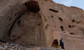 A Taliban soldier stands guard in front of the ruins of a Buddha statue in Bamiyan.