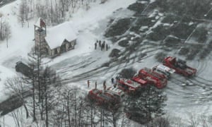 Ambulances and fire vehicles parked at a ski resort in the town of Kusatsu.