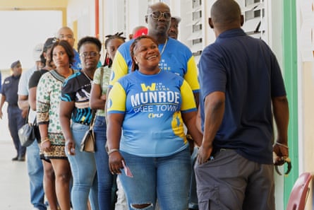 Voters wait in line to cast their ballots in a general election in Nassau on Tuesday.