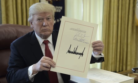 Donald Trump displays his signature after signing the tax cut bill on 22 December 2017.