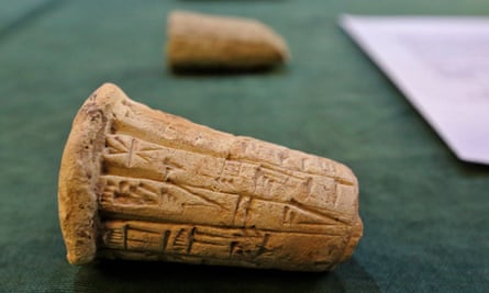 Mesopotamian clay cones bearing cuneiform inscriptions are displayed during the handover ceremony
