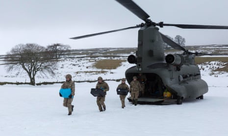 Royal Marines deliver aid to Nenthead, Cumbria, on Monday.