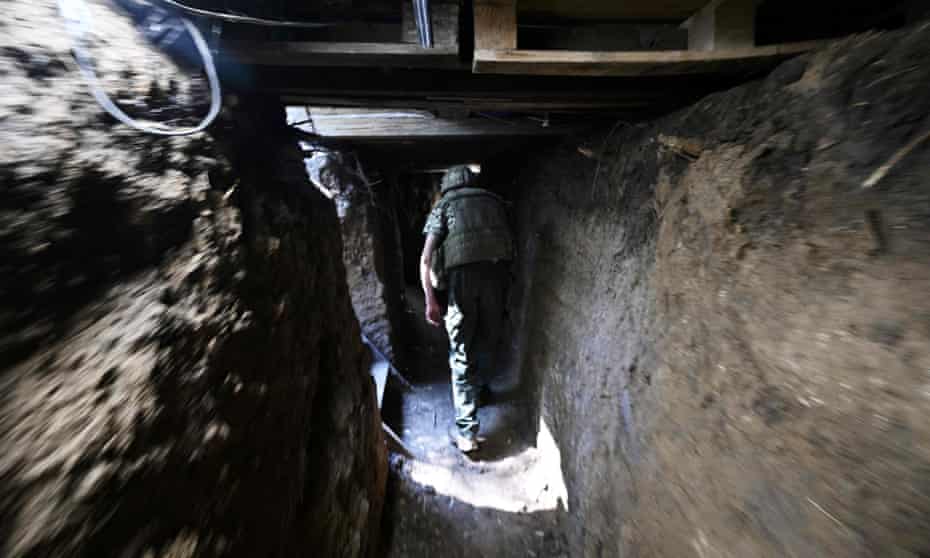A Ukraine soldier in a trench between Mykolaiv and Kherson