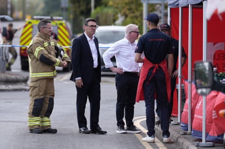 Andy Burnham and Richard Parker chat to fire men at a fire station