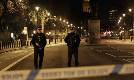 Two police officers stand guard near the Houses of Parliament after the attack.