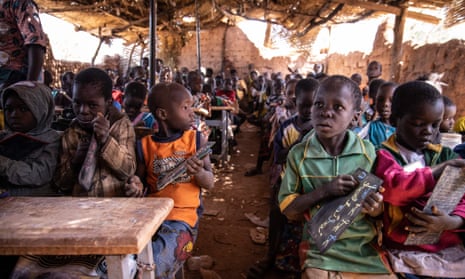 Primary schoolchildren in a classroom under a straw hut, at Koum-Lakre school in Kaya, Burkina Faso.