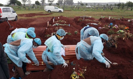 Funeral workers wearing PPE at the burial of a coronavirus victim