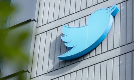 Twitter’s blue bird logo can be seen through the trees on its corporate headquarters building in San Francisco.