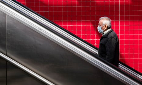A man wearing a face mask exits the subway in Los Angeles. The state’s testing efforts have been hampered by a backlog and by a shortage of test kits. 