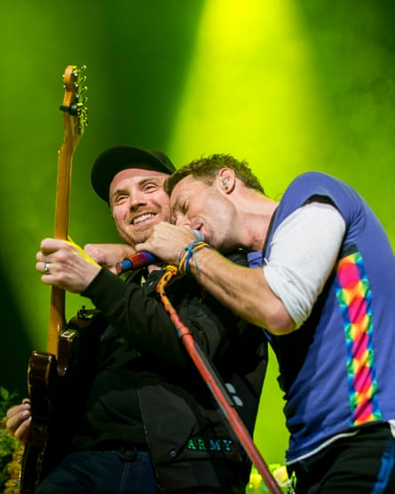 Jonny Buckland and Chris Martin performing