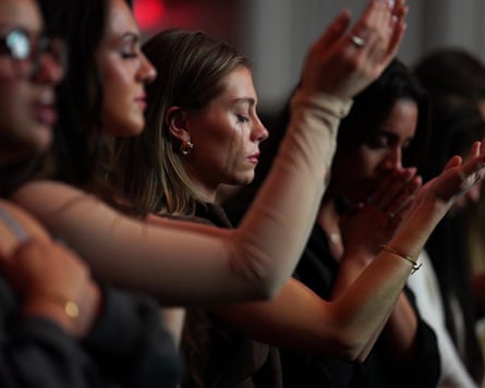 Followers of the Christian podcast Girls Gone Bible cry during their live show stop at the Atlanta Symphony Hall in Atlanta, Georgia, on 14 November 2025.