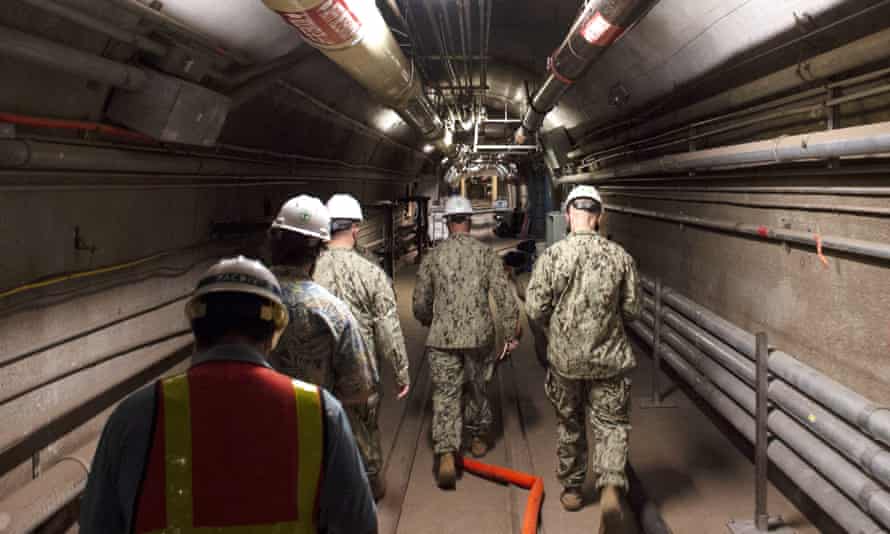 Rear Adm John Korka leads navy and civilian water quality recovery experts through the tunnels of the Red Hill bulk fuel storage facility, near Pearl Harbor in December 2021.